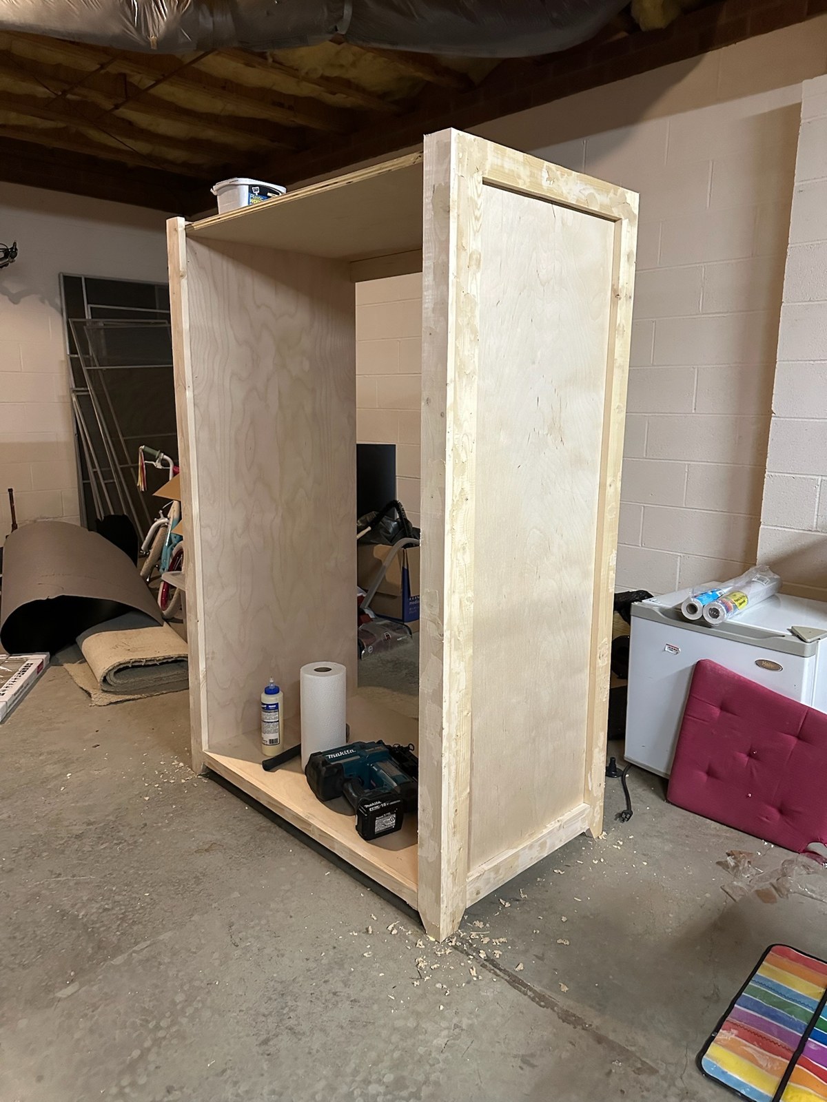 Early cabinet structure with unfinished side panels in the workshop