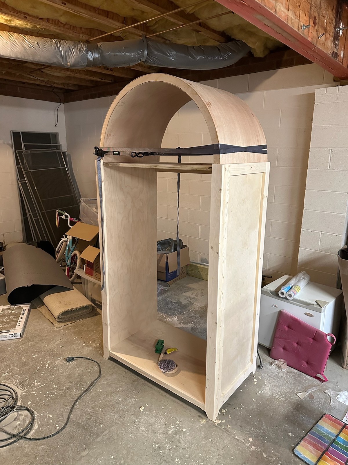Unfinished cabinet with its rounded top fitted