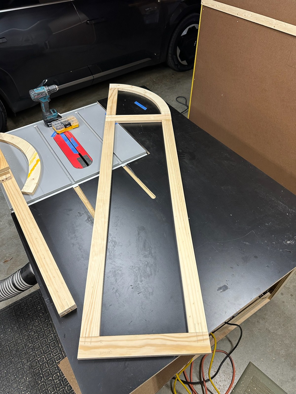 Unfinished arched door frame on the workbench