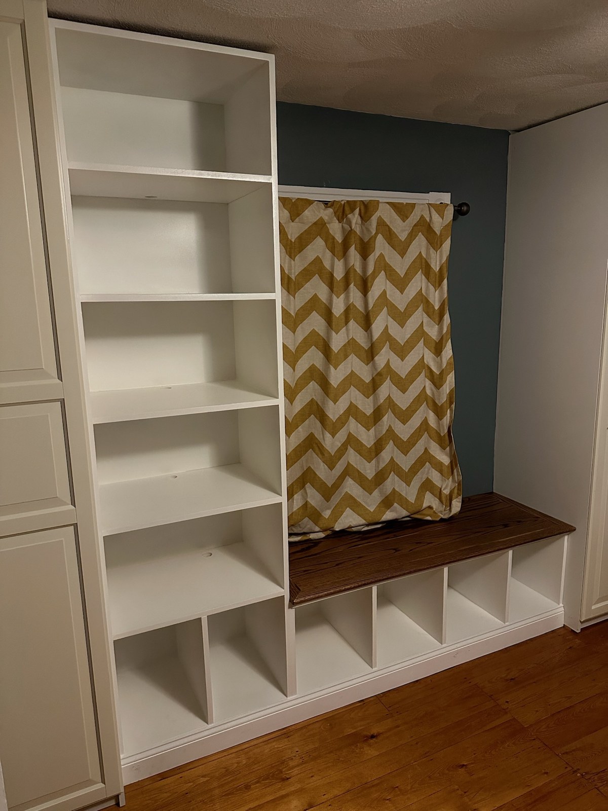 Finished white bookshelf with wood-topped window bench