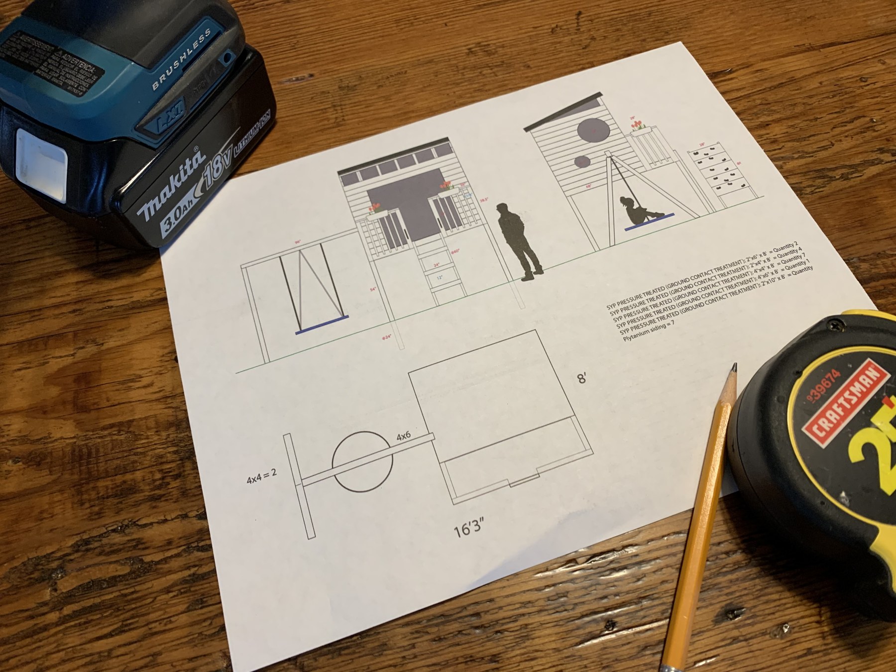 Printed play structure design drawing beside a tape measure and pencil